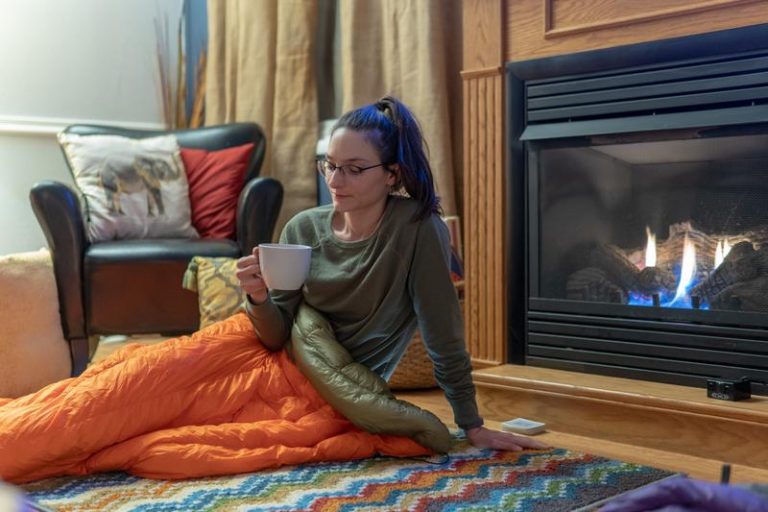 A cozy living room with a woman having a hot drink