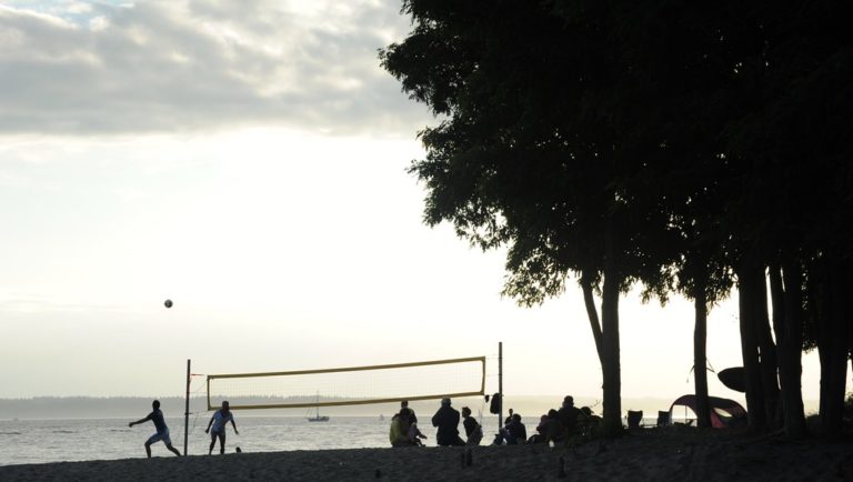 People playing volleyball in a beach