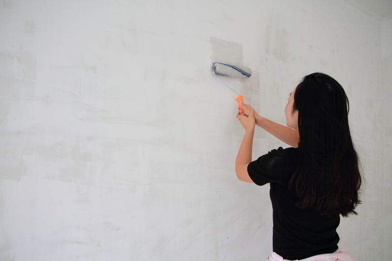 Woman painting a wall